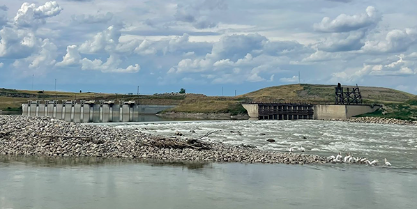 A photo of the Lower Yellowstone Diversion Dam with water rolloing over rocks in the streambed.