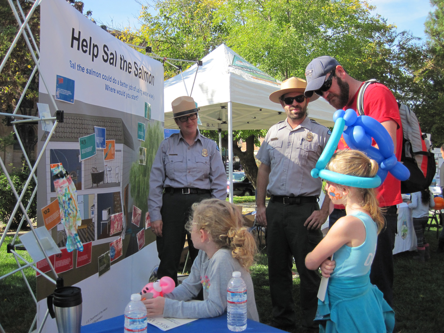 Park rangers help visitors learn about Putah Creek and salmon at the Winters Salmon Festival