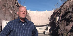 A photo of Kerry McCalman standing in front of Hoover Dam on the Colorado River.