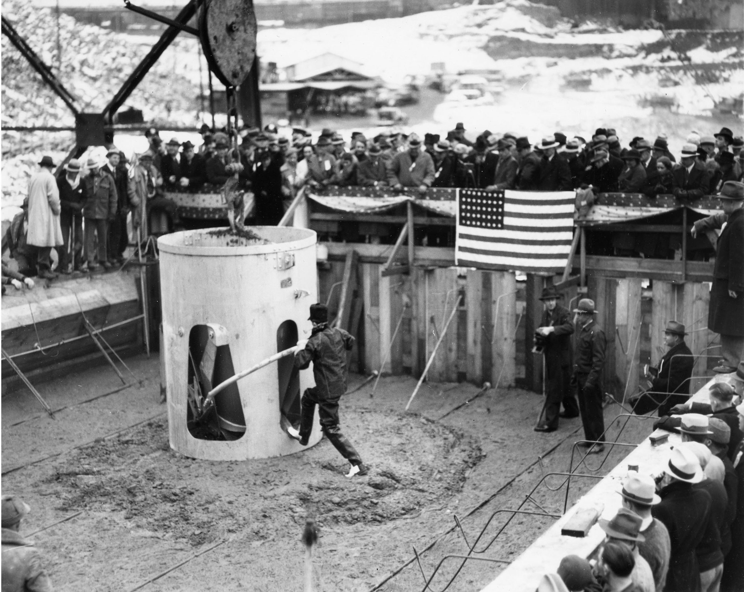December 12, 1935. At the dam's official concrete pour, Washington Governor Clarence D. Martin tips the concrete bucket.