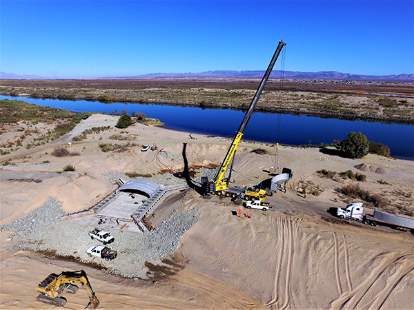 Force Account crews use a crane to place concrete sections of the north inlet bridge in the Mohave Valley Conservation Area.