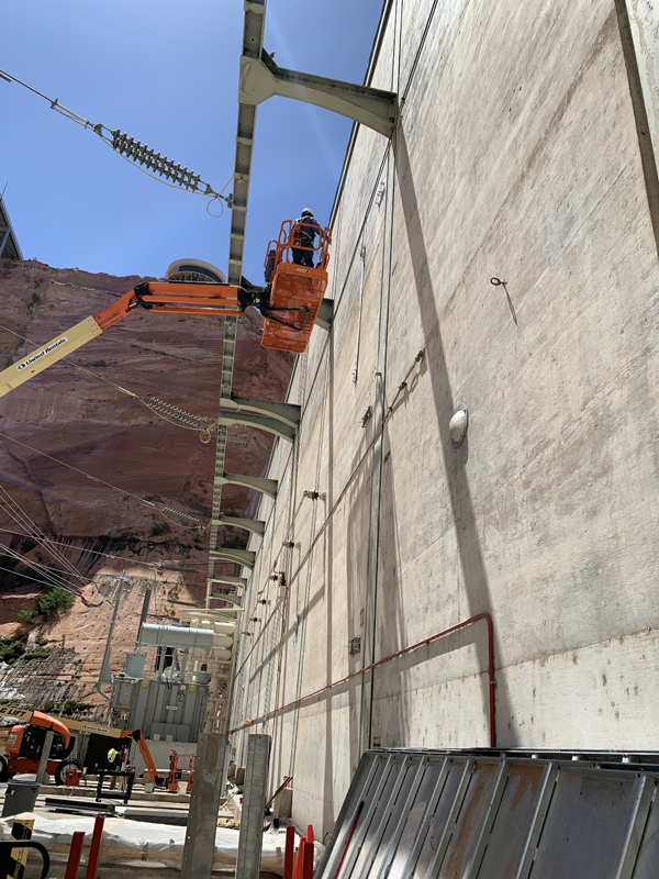 A construction worker finishing the removal of the supporting structure from the K7A transformer bank.