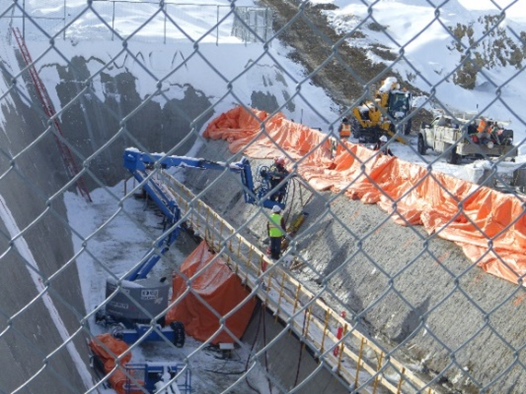 Construction workers fight the Wyoming winter weather to complete work on the spillway as part of an infrastructure improvement project at Big Sandy Dam, Wyoming