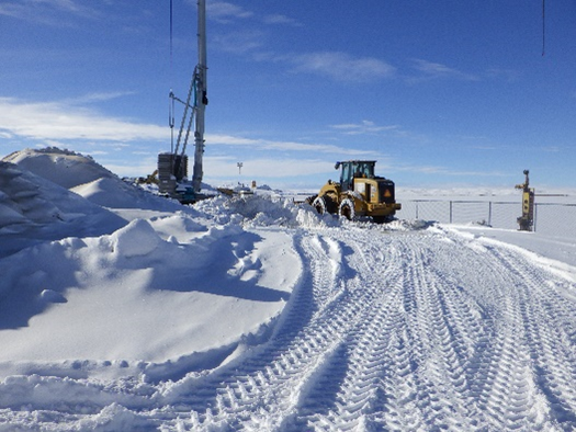 A tractor driver clears the snow from the project site at Big Sandy Dam, Wyoming, so they can continue construction work on a project to rebuild many parts of the aging facility.