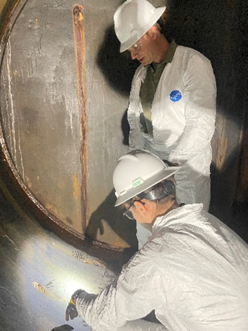 Engineers from Reclamation's Technical Service Center inspect the interior of an outlet pipe at Glen Canyon Dam. The testing and inspection didn't uncover any substantial problems and is part of the effort to accelerate maintenance of the outlets