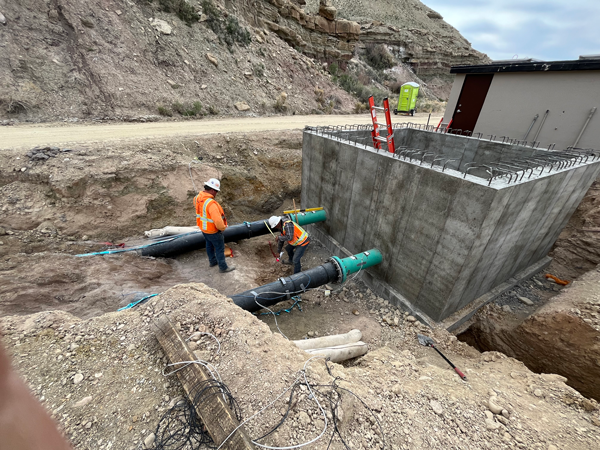 Contractor foreman marking thrust block foot print upstream of Meter Vault